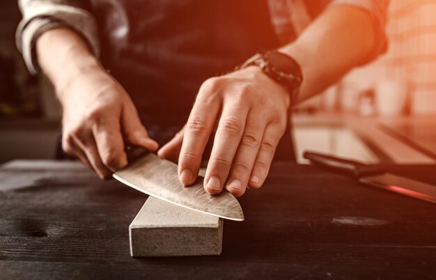 man-sharpening-knife-with-whetstone